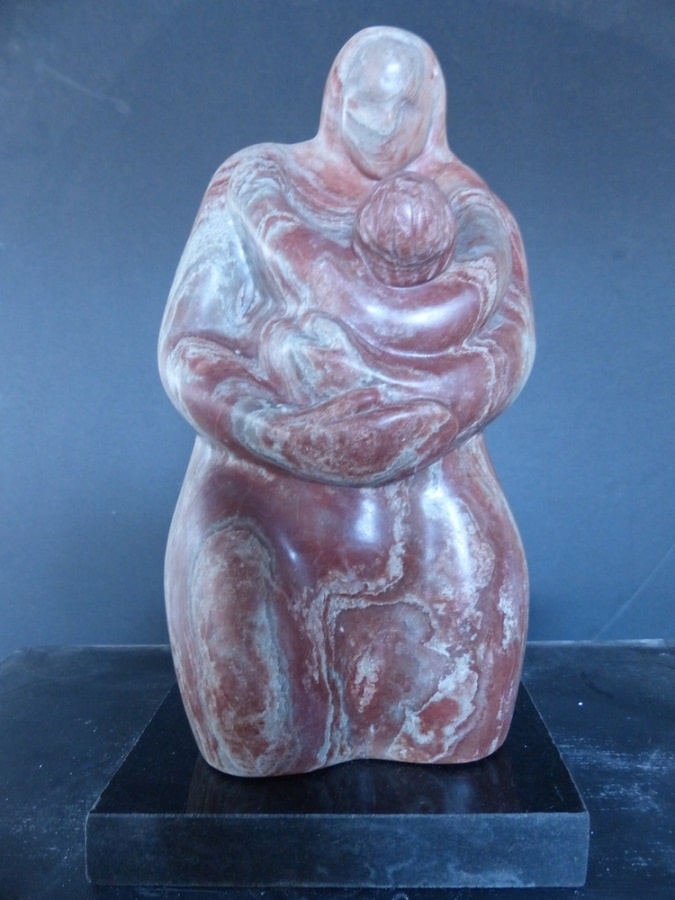 An alabaster mother and child tabletop sculpture